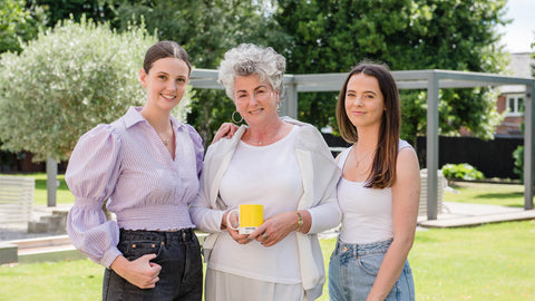 Photo showing Maxine, Margot and Darcy Laceby standing in a garden and smiling
