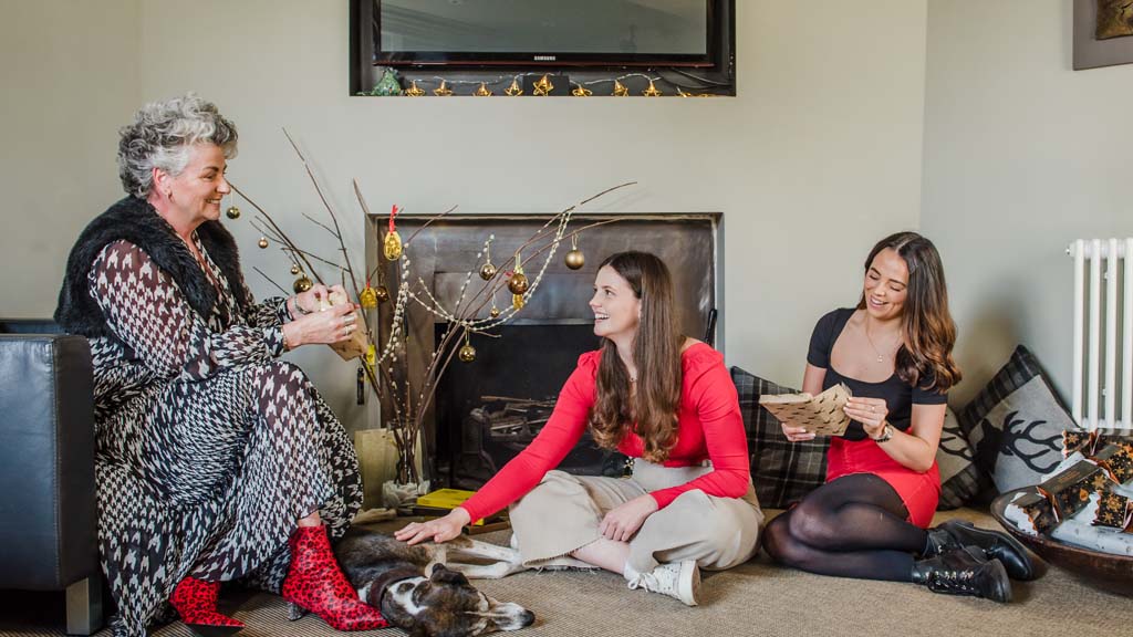 Photo of Maxine Laceby, Darcy Laceby and Margot Laceby sitting in a festively decorated room